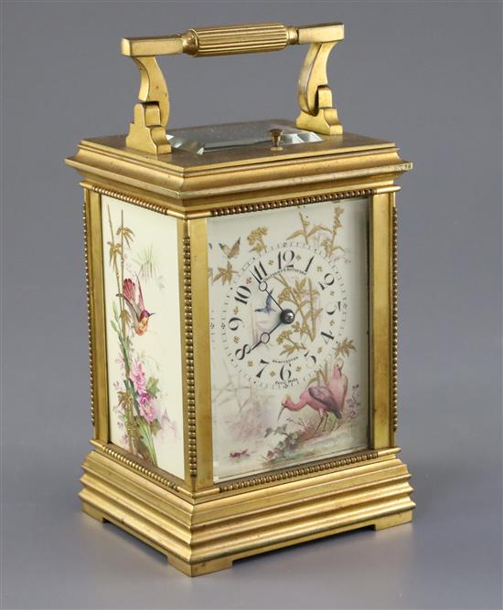 An early 20th century ormolu and porcelain hour repeating carriage clock, 6.5in., with travelling case
